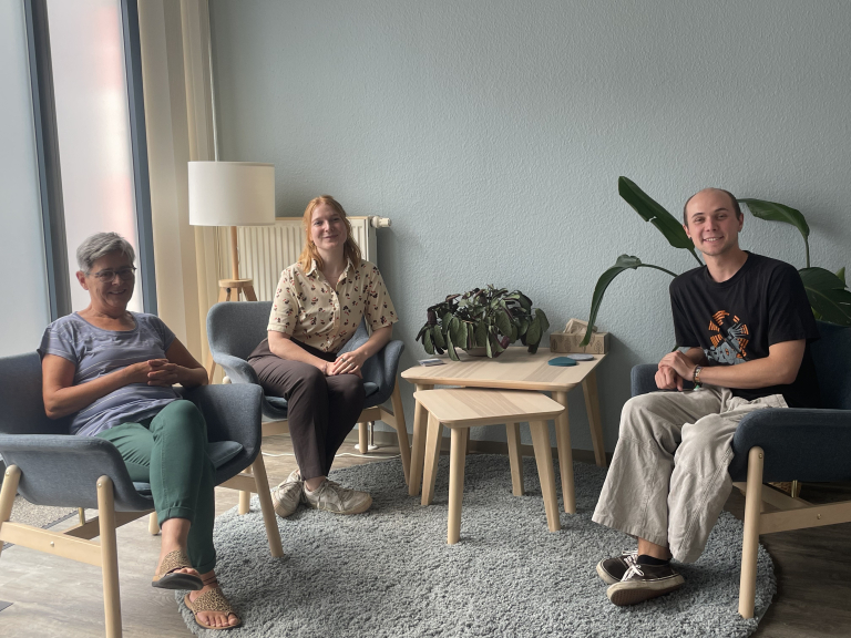Eva Jochmann, Leah Krieger und Jassin Queiroz de Souza sitzen in einer Beratungsecke der Männer*beratung